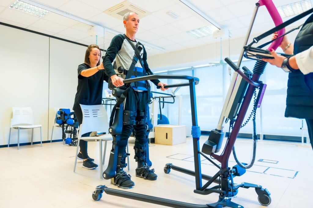 patient being helped with exoskeleton