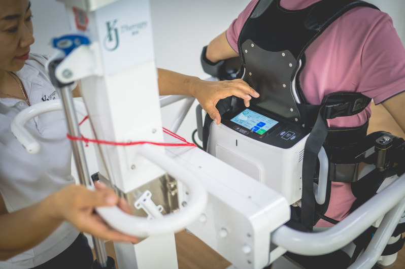 nurse putting on exoskeleton for patient