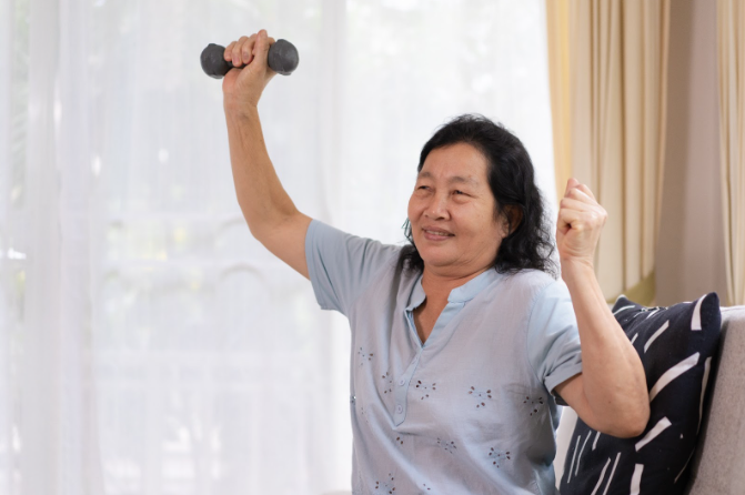 elderly woman exercising with dumbbells
